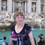 A woman by a fountain in Italy.